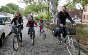 Familia feliz paseando en bici